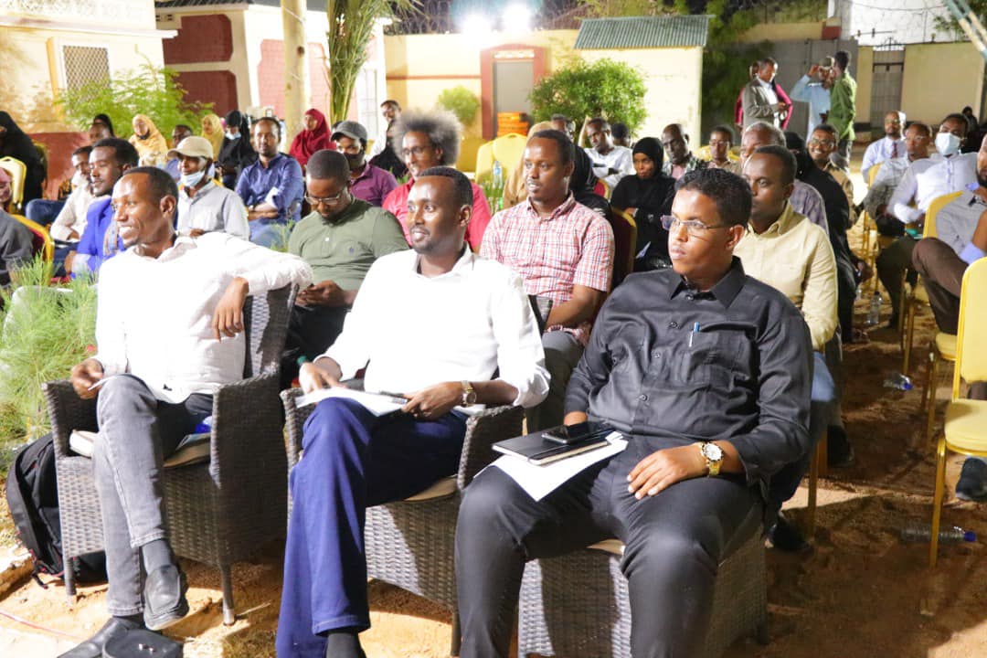 Rows of engaged participants following the debate at the public forum